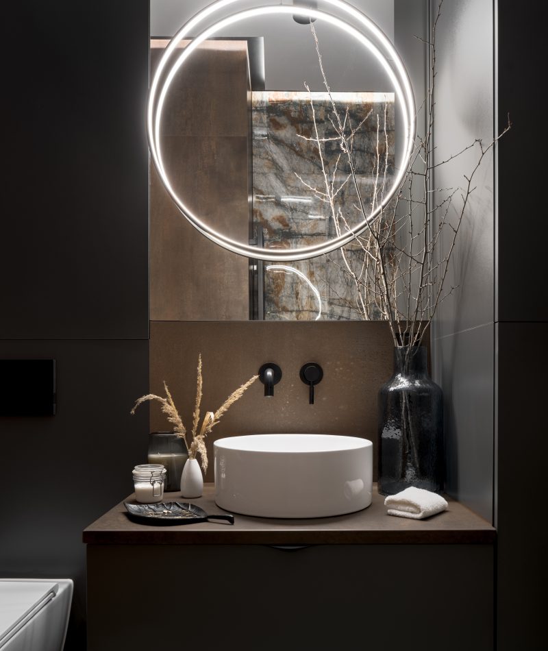 Elegant, round led lamp in modern bathroom Elegant, round led lamp over oval washbasin and big mirror in modern bathroom